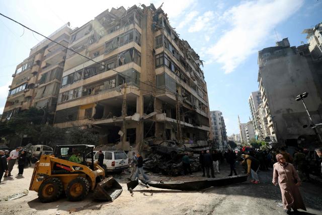 People walk at the site of an Israeli airstrike that targeted a building the day before in Beirut's Corniche al-Mazraa neighbourhood on April 9, 2026. Rescuers searched for survivors under the rubble of destroyed buildings in Beirut as Lebanon observed a day of mourning after Israeli strikes across the country killed more than 200. (Photo by Ibrahim AMRO / AFP)