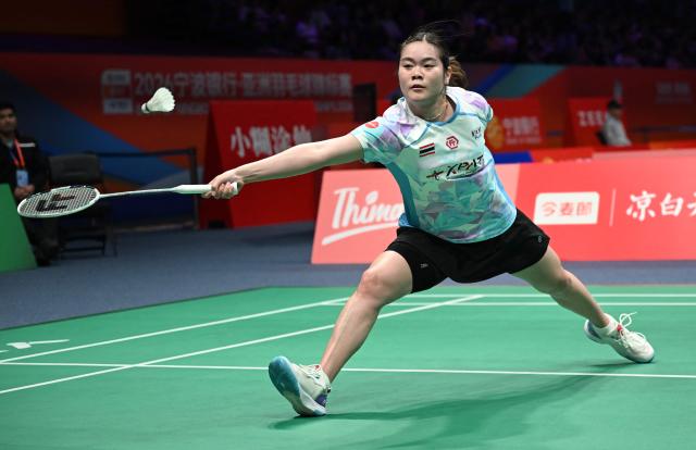 Busanan Ongbamrungphan of Thailand hits a return to Akane Yamaguchi of Japan during their women's single match at the Badminton Asia Championship in Ningbo, eastern China's Zhejiang province on April 9, 2026. (Photo by CN-STR / AFP) / China OUT