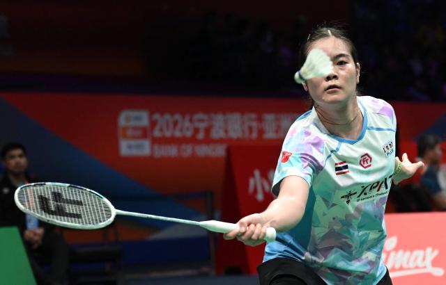 Busanan Ongbamrungphan of Thailand hits a return to Akane Yamaguchi of Japan during their women's single match at the Badminton Asia Championship in Ningbo, eastern China's Zhejiang province on April 9, 2026. (Photo by CN-STR / AFP) / China OUT
