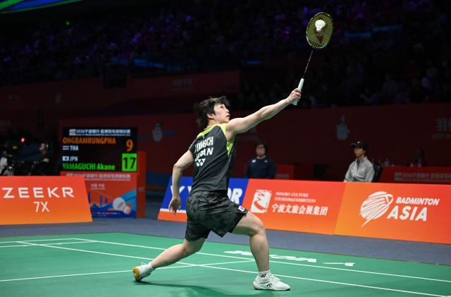 Akane Yamaguchi of Japan hits a return to Busanan Ongbamrungphan of Thailand during their women's single match at the Badminton Asia Championship in Ningbo, eastern China's Zhejiang province on April 9, 2026. (Photo by CN-STR / AFP) / China OUT