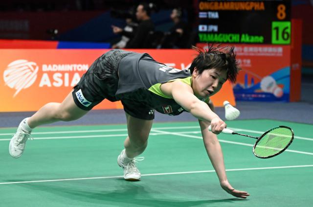 Akane Yamaguchi of Japan hits a return to Busanan Ongbamrungphan of Thailand during their women's single match at the Badminton Asia Championship in Ningbo, eastern China's Zhejiang province on April 9, 2026. (Photo by CN-STR / AFP) / China OUT