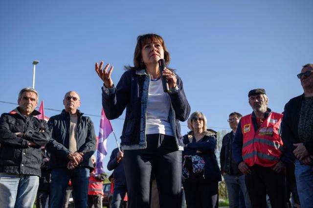 Attendees gather around regional council president and Socialist Party politician Carole Delga as she speaks during a rally against the potential closure of paper pulp producer Fibre Excellence group's Saint-Gaudens site as the company faces a potential receivership, in Saint-Gaudens, south western France on April 9, 2026. The Fibre Excellence group, which employs 670 people, 275 in Saint-Gaudens and 270 in Tarascon, produces 500,000 tonnes annually out of the two million tonnes of paper pulp consumed in France. It is owned by Jackson Wijaya, whose family runs the Indonesian global paper giant Asia Pulp and Paper. (Photo by Ed JONES / AFP)