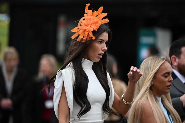 A racegoer arrives on the opening day of the Grand National Festival horse race meeting at Aintree Racecourse in Liverpool, north-west England, on April 9, 2026. (Photo by Paul ELLIS / AFP)