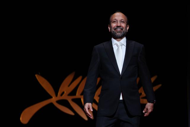 (FILES) Iranian film director and member of the Jury of the Official Selection Asghar Farhadi arrives on stage during the Opening Ceremony of the 75th edition of the Cannes Film Festival in Cannes, southern France, on May 17, 2022. Iranian filmmaker Asghar Farhadi, Pedro Almodovar – making his seventh appearance in the competition – exiled Russian director Andrei Zvyagintsev, and previous winners Hirokazu Kore-eda and Cristian Mungiu will be vying for the Palme d’Or at the 79th Cannes Film Festival. The selection, announced on April 9, 2026, includes just one US director, Ira Sachs, whilst the major Hollywood studios are notably absent from this year’s festival, which will take place from May 12 to 23, 2026. (Photo by Valery HACHE / AFP)