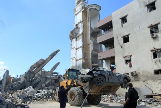 The wreckage of a car is cleared from the site of an Israeli airstrike that targeted a religious Shiite complex the day before in the southern Lebanese coastal city of Sidon on April 9, 2026. Calls were mounting for the ceasefire between the US and Iran to be extended to Israel's war with Hezbollah, after a massive wave of Israeli strikes on Lebanon killed more than 200 people. (Photo by Mahmoud ZAYYAT / AFP)