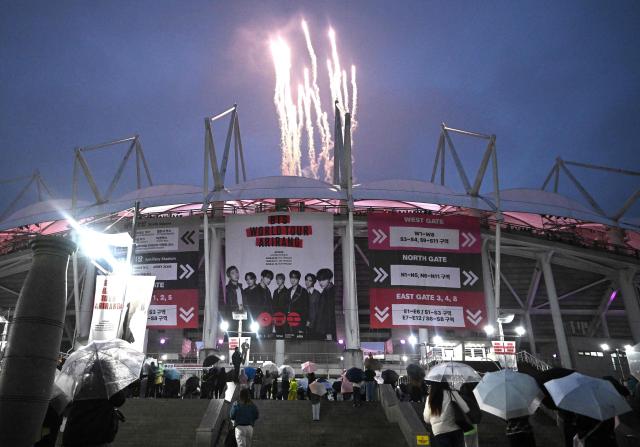 Fireworks explode at a stadium where K-pop boy band BTS is performing in Goyang on April 9, 2026. South Korean K-pop megastars BTS kicked off their world tour on April 9, riding the momentum of a chart-topping comeback album and a landmark performance in the heart of Seoul. (Photo by Jung Yeon-je / AFP)