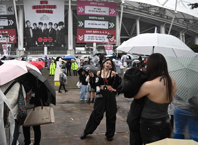 BTS fans arrive at a stadium where K-pop boy band BTS will perform in Goyang on April 9, 2026. South Korean K-pop megastars BTS kicked off their world tour on April 9, riding the momentum of a chart-topping comeback album and a landmark performance in the heart of Seoul. (Photo by Jung Yeon-je / AFP)