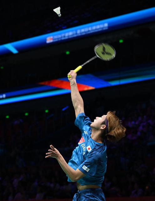Kodai Naraoka of Japan hits a return to Alwi Farhan of Indonesia during their men's singles match at the Badminton Asia Championship in Ningbo, eastern China's Zhejiang province on April 9, 2026. (Photo by CN-STR / AFP) / China OUT