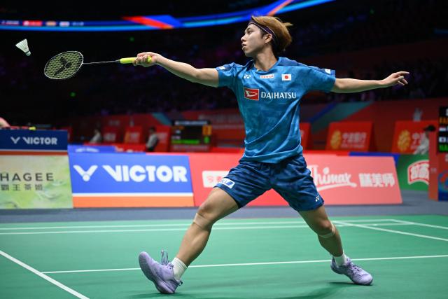Kodai Naraoka of Japan hits a return to Alwi Farhan of Indonesia during their men's singles match at the Badminton Asia Championship in Ningbo, eastern China's Zhejiang province on April 9, 2026. (Photo by CN-STR / AFP) / China OUT