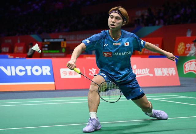 Kodai Naraoka of Japan hits a return to Alwi Farhan of Indonesia during their men's singles match at the Badminton Asia Championship in Ningbo, eastern China's Zhejiang province on April 9, 2026. (Photo by CN-STR / AFP) / China OUT