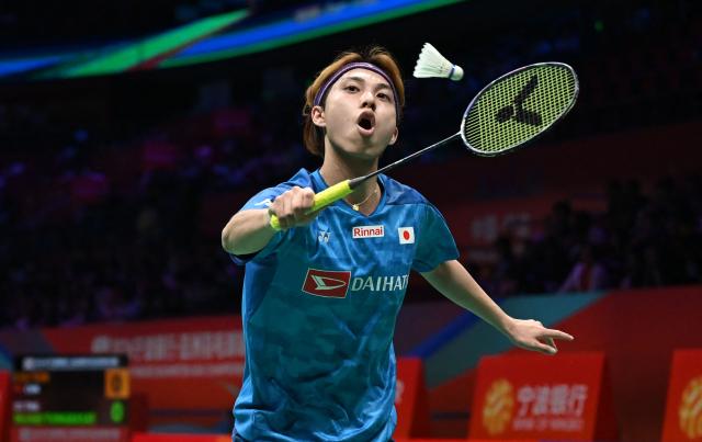 Kodai Naraoka of Japan hits a return to Alwi Farhan of Indonesia during their men's singles match at the Badminton Asia Championship in Ningbo, eastern China's Zhejiang province on April 9, 2026. (Photo by CN-STR / AFP) / China OUT
