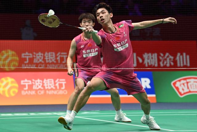 Hu Keyuan (back) and Lin Xiangyi (front) of China hit a return to Aaron Chia and Soh Wooi Yik of Malaysia during their men's doubles match at the Badminton Asia Championship in Ningbo, eastern China's Zhejiang province on April 9, 2026. (Photo by CN-STR / AFP) / China OUT
