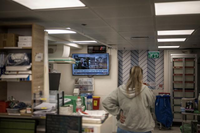 A nurse looks on as a television channel broadcasts news, at the neonatal unit in the underground bomb shelter built into the Carmel Medical Center in the northern Israeli city of Haifa, on April 9, 2026. The hospital, built in the tip of the one of the mountains of the Carmel Mountain Range is part of the Clalit Health Services, the largest health organisation in Israel running 14 hospitals across the country. At least 14 rocket alerts sounded through April 9 morning in communities near Israel's northern border with Lebanon as Israeli forces fight Hezbollah despite the US-Iran ceasefire. (Photo by MARCO LONGARI / AFP)