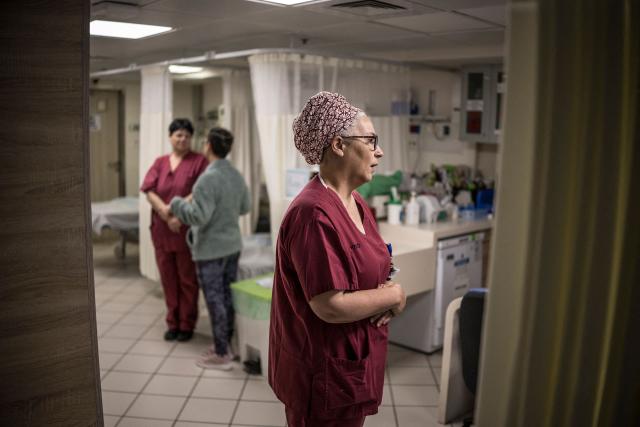 Miri Yahalom (C), Chief Midwife of the delivery room performs the morning rounds in the underground bomb shelter built into the Carmel Medical Center in the northern city of Haifa, on April 9, 2026. The hospital, built in the tip of the one of the mountains of the Carmel Mountain Range is part of the Clalit Health Services, the largest health organisation in Israel running 14 hospitals across the country. At least 14 rocket alerts sounded through April 9 morning in communities near Israel's northern border with Lebanon as Israeli forces fight Hezbollah despite the US-Iran ceasefire. (Photo by MARCO LONGARI / AFP)