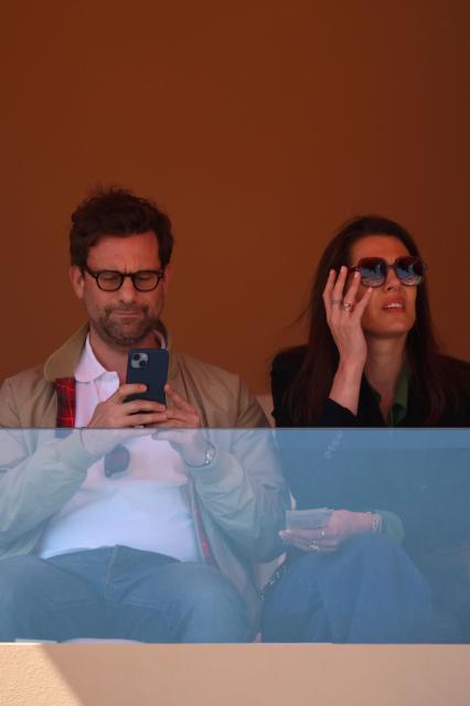 Charlotte Casiraghi (R) and her partner French writer Nicolas Mathieu attend the match opposing Italy's Jannik Sinner and Czech Republic's Tomas Machac during their Monte Carlo ATP Masters Series Tournament round of 16 tennis match on Court Rainier III at the Monte-Carlo Country Club in Roquebrune-Cap-Martin, south-eastern France on April 9, 2026. (Photo by Valery HACHE / AFP) / / NO TABLOIDS WEB & PRINT, NO DAILY MAIL, NO DAILY MAIL GROUP, NO VOICI, NO CLOSER
