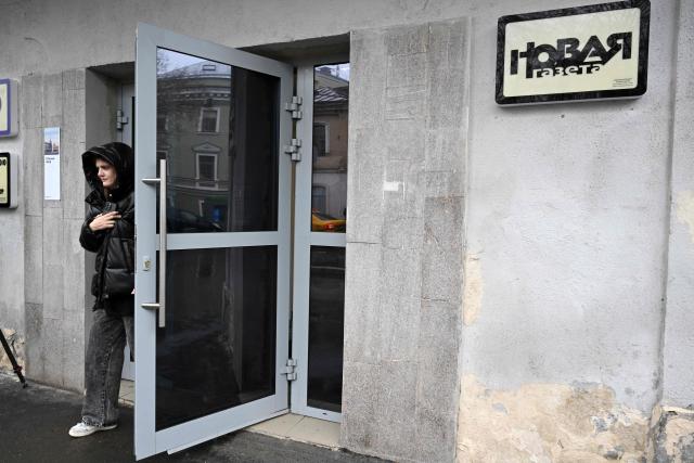 A woman leaves a building housing the editorial office of the Novaya Gazeta independent media outlet in Moscow on April 9, 2026. Russian law enforcement agents were on April 9, 2026 raiding the offices of the Novaya Gazeta independent media outlet, the paper said. Novaya Gazeta was for years Russia's leading investigative independent outlet and was targeted heavily for its critical reporting and investigations into human rights abuses. The paper, which used to be published several times a week, cut down production from inside the country after Russia introduced military censorship at the start of its offensive on Ukraine in 2022. (Photo by Igor IVANKO / AFP)