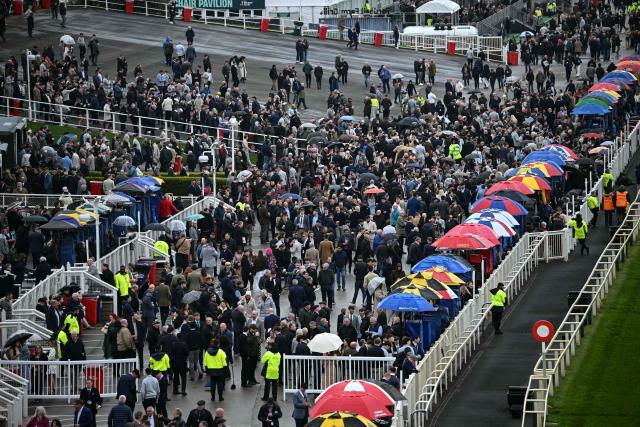Racegoers attend the opening day of the Grand National Festival horse race meeting at Aintree Racecourse in Liverpool, north-west England, on April 9, 2026. (Photo by Paul ELLIS / AFP)