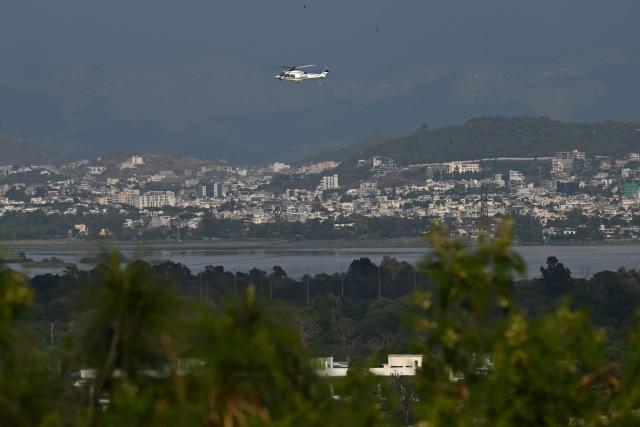 A helicopter flies over the Red Zone area in Islamabad on April 9, 2026. Pakistan has been preparing for high-stakes talks involving US and Iranian representatives over the war in the Middle East, with the White House saying Vice President JD Vance will be leading a team to the negotiations in Islamabad "this weekend". (Photo by Aamir QURESHI / AFP)
