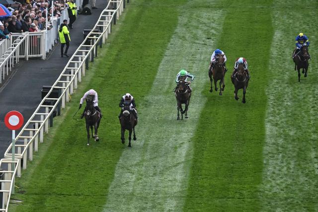 Mange Tout (2nd L) wins the 'Boodles Anniversary 4-Y-O Juvenile Hurdle' first race of the day on the opening day of the Grand National Festival horse race meeting at Aintree Racecourse in Liverpool, north-west England, on April 9, 2026. (Photo by Paul ELLIS / AFP)