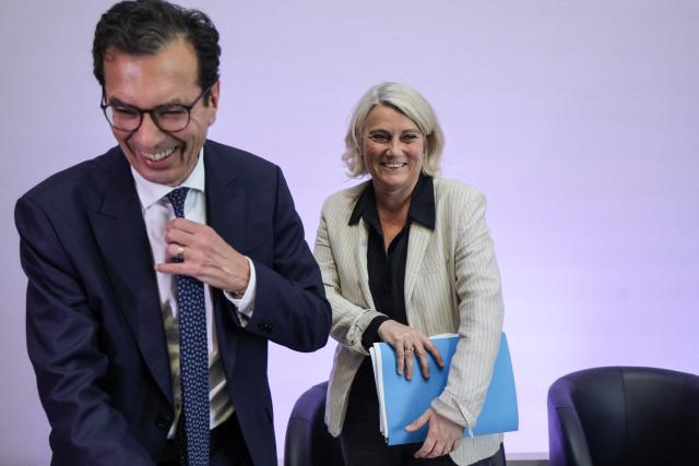 France's Labour Minister Jean-Pierre Farandou (L) and France's Health Minister Stephanie Rist (R) react at the end of a press conference to present the plan to reduce absenteeism at work, in Paris on April 9, 2026. France's Health Minister confirmed to the National Assembly on April 1, 2026 that the government is preparing to announce measures to curb the current rise in sick pay, which is "no longer sustainable" for the National Health Service. This also includes making it easier for employers to monitor absenteeism and providing employers with guidelines on best practice regarding working conditions. (Photo by Ludovic MARIN / AFP)