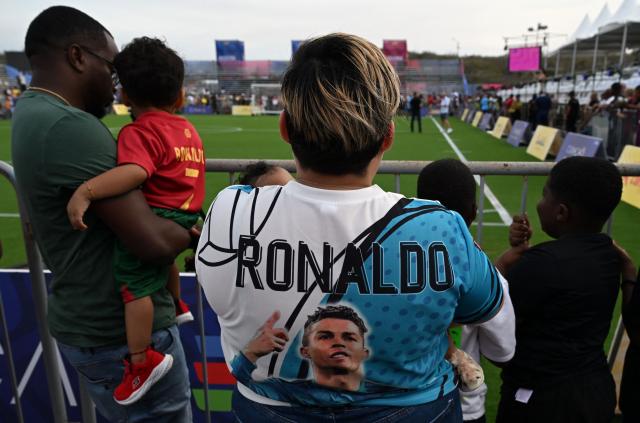 A woman wears a jersey depicting Portuguese football star Cristiano Ronaldo during the Legends Football Tournament in Willemstad, Curacao, in the Dutch Caribbean, on April 8, 2026. (Photo by Raul ARBOLEDA / AFP)