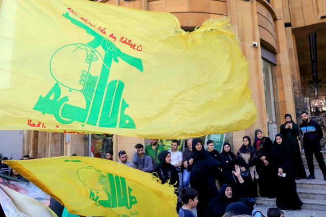 Hezbollah supporters wave flags as they stage an anti-government protest outside the Lebanese governmental palace in Beirut on April 9, 2026. Lebanon's cabinet on April 9 instructed security forces to restrict weapons in Beirut exclusively to state institutions, in a warning to Hezbollah a day after Israel launched strikes across the country including the capital. (Photo by Ibrahim AMRO / AFP)