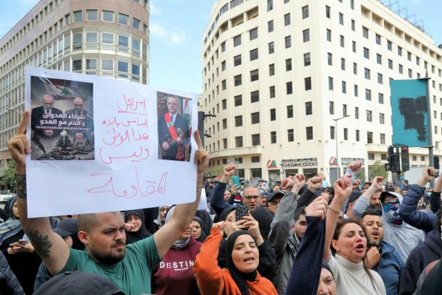 Hezbollah supporters wave flags as they stage an anti-government protest outside the Lebanese governmental palace in Beirut on April 9, 2026. Lebanon's cabinet on April 9 instructed security forces to restrict weapons in Beirut exclusively to state institutions, in a warning to Hezbollah a day after Israel launched strikes across the country including the capital. (Photo by Ibrahim AMRO / AFP)