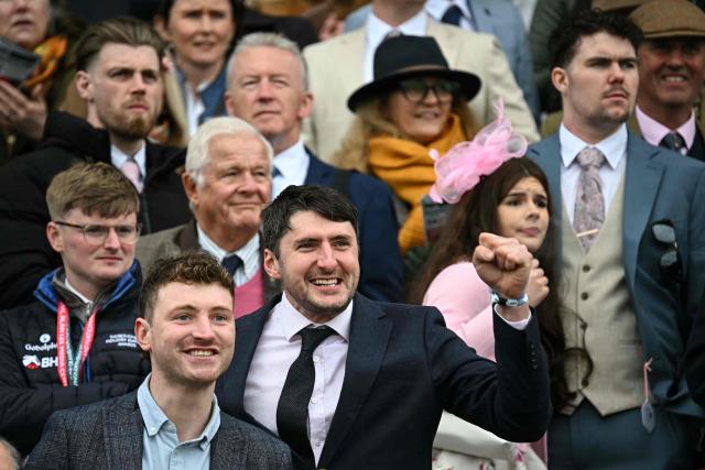 Racegoers react as they watch the second race of the day on the opening day of the Grand National Festival horse race meeting at Aintree Racecourse in Liverpool, north-west England, on April 9, 2026. (Photo by Paul ELLIS / AFP)