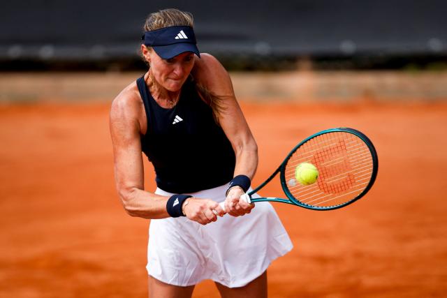 France's Kristina Mladenovic hits a backhand return during her women's singles match against Romania’s Carmen Andreea Herea during the Billie Jean King Cup play-offs between France and Romania, at Oeiras on the outskirts of Lisbon, on April 9, 2026. (Photo by FILIPE AMORIM / AFP)