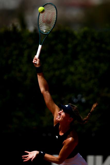 France's Kristina Mladenovic serves a ball in her women's singles match against Romania’s Carmen Andreea Herea during the Billie Jean King Cup play-offs between France and Romania, at Oeiras on the outskirts of Lisbon, on April 9, 2026. (Photo by FILIPE AMORIM / AFP)