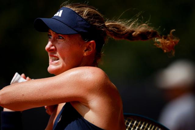 France's Kristina Mladenovic watches after hitting a return shot during her women's singles match against Romania’s Carmen Andreea Herea during the Billie Jean King Cup play-offs between France and Romania, at Oeiras on the outskirts of Lisbon, on April 9, 2026. (Photo by FILIPE AMORIM / AFP)