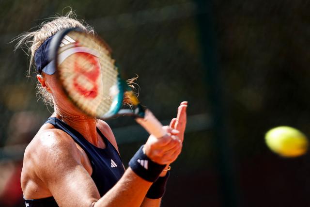 France's Kristina Mladenovic hits a return in her women's singles match against Romania’s Carmen Andreea Herea during the Billie Jean King Cup play-offs between France and Romania, at Oeiras on the outskirts of Lisbon, on April 9, 2026. (Photo by FILIPE AMORIM / AFP)