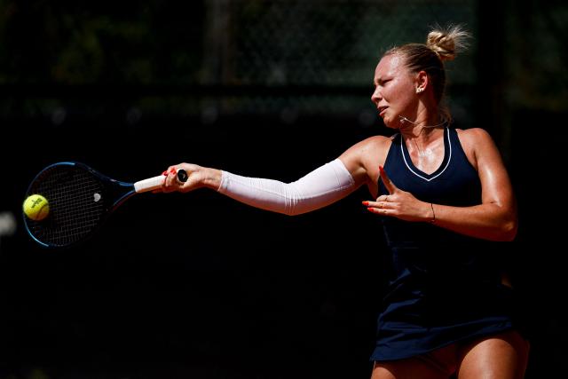 Romania’s Carmen Andreea Herea hits a return in her women's singles match against France's Kristina Mladenovic during the Billie Jean King Cup play-offs between France and Romania, at Oeiras on the outskirts of Lisbon, on April 9, 2026. (Photo by FILIPE AMORIM / AFP)