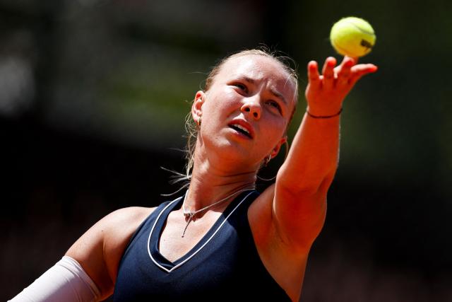 Romania’s Carmen Andreea Herea serves a ball in her women's singles match against France's Kristina Mladenovic during the Billie Jean King Cup play-offs between France and Romania, at Oeiras on the outskirts of Lisbon, on April 9, 2026. (Photo by FILIPE AMORIM / AFP)