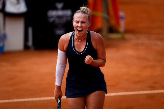Romania’s Carmen Andreea Herea reacts during her women's singles match against France's Kristina Mladenovic during the Billie Jean King Cup play-offs between France and Romania, at Oeiras on the outskirts of Lisbon, on April 9, 2026. (Photo by FILIPE AMORIM / AFP)