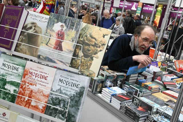 A man sells books at the Non/Fiction book fair in Moscow on April 9, 2026. (Photo by Igor IVANKO / AFP)