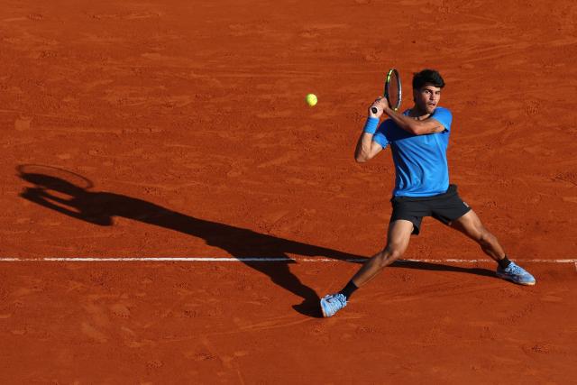 Spain's Carlos Alcaraz returns to Argentina's Tomas Martin Etcheverry during their Monte Carlo ATP Masters Series Tournament round of 16 tennis match on Court Rainier III at the Monte-Carlo Country Club in Roquebrune-Cap-Martin, south-eastern France on April 9, 2026. (Photo by Valery HACHE / AFP)