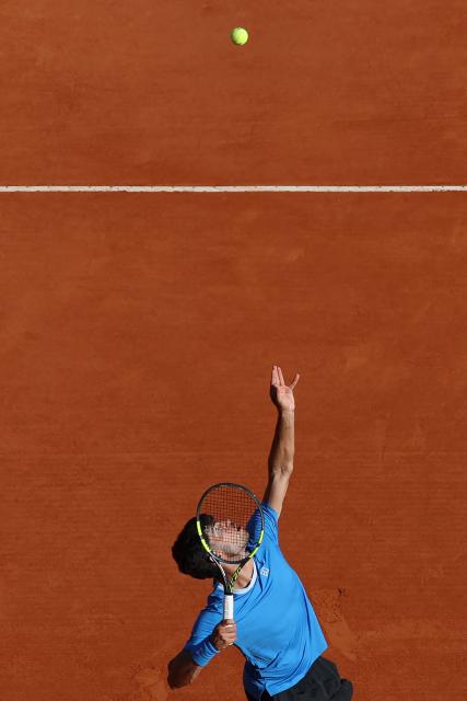 Spain's Carlos Alcaraz eyes the ball to serve to Argentina's Tomas Martin Etcheverry during their Monte Carlo ATP Masters Series Tournament round of 16 tennis match on Court Rainier III at the Monte-Carlo Country Club in Roquebrune-Cap-Martin, south-eastern France on April 9, 2026. (Photo by Valery HACHE / AFP)