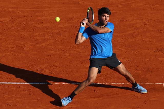 Spain's Carlos Alcaraz returns to Argentina's Tomas Martin Etcheverry during their Monte Carlo ATP Masters Series Tournament round of 16 tennis match on Court Rainier III at the Monte-Carlo Country Club in Roquebrune-Cap-Martin, south-eastern France on April 9, 2026. (Photo by Valery HACHE / AFP)
