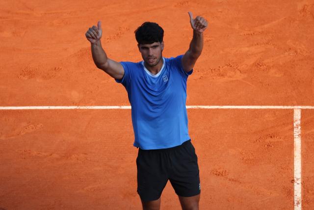 Spain's Carlos Alcaraz celebrates his victory over Argentina's Tomas Martin Etcheverry at the end of their their Monte Carlo ATP Masters Series Tournament round of 16 tennis match on Court Rainier III at the Monte-Carlo Country Club in Roquebrune-Cap-Martin, south-eastern France on April 9, 2026. (Photo by Valery HACHE / AFP)