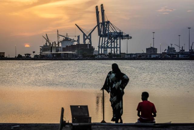 A couple observes the sunset as cargo ships are docked at a section of the port of Djibouti, the country’s main economic hub, in Djibouti, on April 9, 2026. (Photo by Luis TATO / AFP)