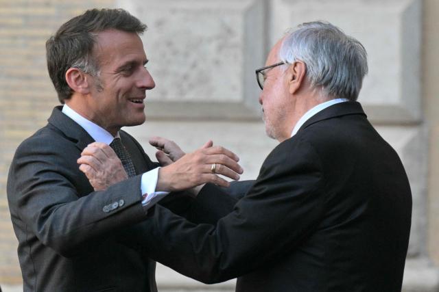 France's President Emmanuel Macron is welcomed by the founder of the catholic charity Sant'Egidio community, Andrea Riccardi at the Sant'Egidio headquarters in Rome on April 9, 2026. (Photo by Tiziana FABI / AFP)