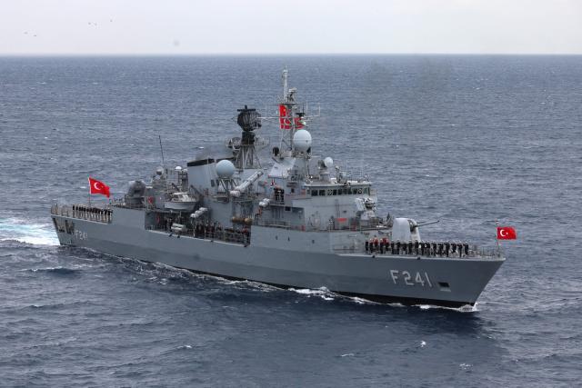 Servicemen of Yavuz class, TCG Turgutreis (F-241), warship stand at attention on the deck as they participate in the live-fire phase of the "Blue Homeland-2026" (Mavi Vatan) tactical military exercises in the eastern Mediterranean Sea, in Antalya on April 9, 2026. (Photo by Adem ALTAN / AFP)