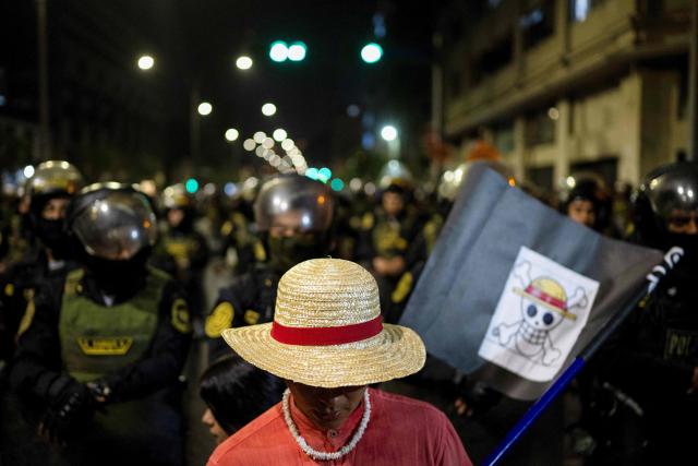 (FILES) A demonstrator of the Gen Z movement wears a One Piece manga costume during a protest against the government of Peru's President Jose Jeri in Lima on November 14, 2025. Decisive yet disillusioned, Peru's young people will be key in the April 12, 2026, election to choose a president from a record field of 35 candidates, but with no options that excite them. (Photo by Ernesto BENAVIDES / AFP)