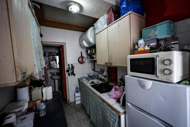 This photograph shows a kitchen inside an appartment in an unsanitary housing building in central Paris on April 9, 2026. (Photo by STEPHANE DE SAKUTIN / AFP)