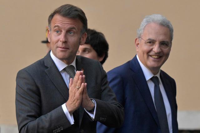 France's President Emmanuel Macron (L) is welcomed by the president of catholic charity Sant'Egidio community, Marco Impagliazzo, in Rome on April 9, 2026. (Photo by Tiziana FABI / AFP)