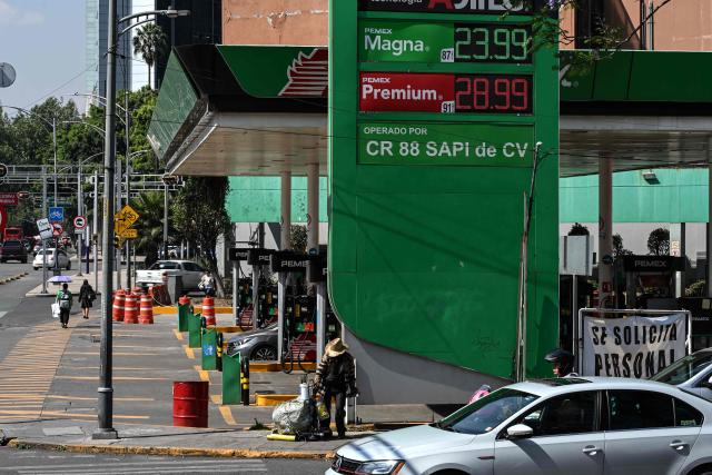 An electronic display shows the price of premium gasoline (28.99 MXN) and magna gasoline (23.99 MXN)—equivalent to approximately 1.66 USD and 1.37 USD per liter, respectively— at a gas station operated by the state-owned company Petroleos Mexicanos (PEMEX) in Mexico City on April 9, 2026. (Photo by Yuri CORTEZ / AFP)