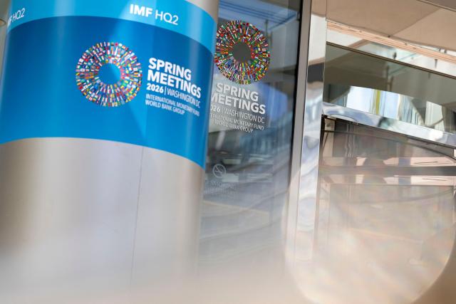 Signage for the upcoming International Monetary Fund (IMF) 2026 Spring Meetings are seen outside of the IMF headquarters in Washington, DC on April 9, 2026. The International Monetary Fund will lower global growth forecasts due to the Middle East war, its chief said April 9, warning of the conflict's "scarring effects" despite a fragile ceasefire. "Even in a best case, there will be no neat and clean return to the status quo ante," IMF managing director Kristalina Georgieva said. (Photo by Kent Nishimura / AFP)