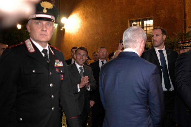 France's President Emmanuel Macron walks in Trastevere district after a visit at the catholic charity Sant'Egidio community,  in Rome on April 9, 2026. (Photo by Tiziana FABI / AFP)