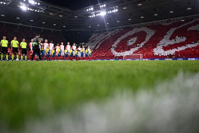 Players and referees stand during the ceremony ahead of the UEFA Europa Conference League quarter-final first leg football match between 1 FSV Mainz 05 and RC Strasbourg Alsace in Mainz, western Germany on April 9, 2026. (Photo by Kirill KUDRYAVTSEV / AFP)